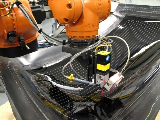 Robot Dispensing Defroster Lines from EXATEC-Designed and Built Dispensing System
