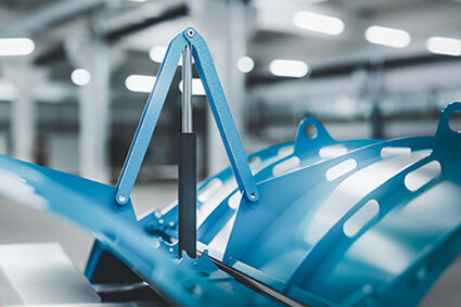 In the foreground is a blue perforated sheet-metal body that serves as a drum or screen.